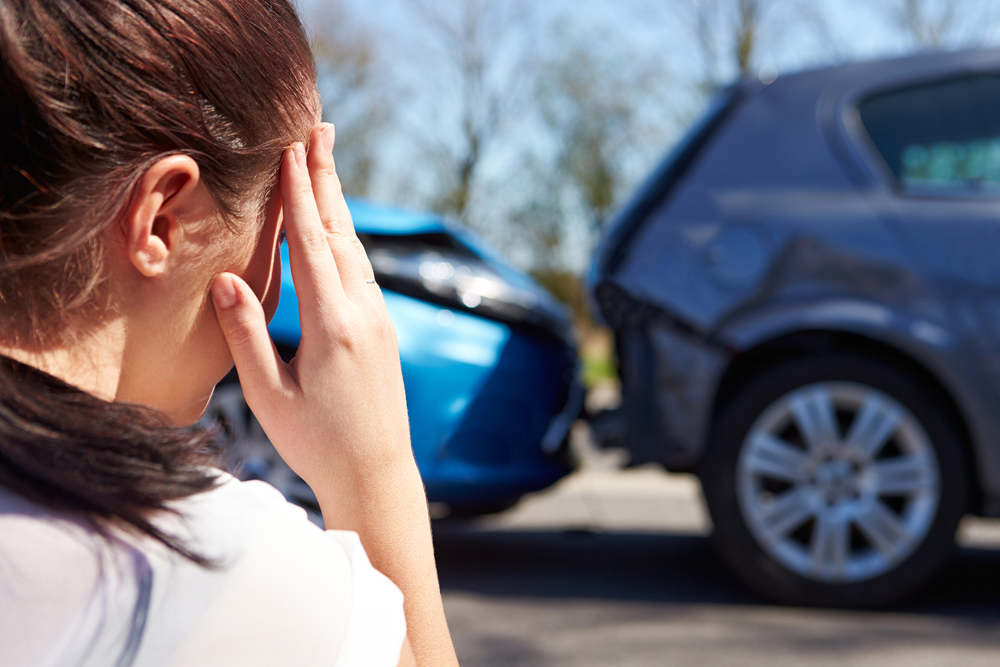 women has a headache from a car accident