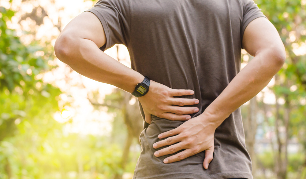 Man with back pain needs chiropractic care in San Antonio