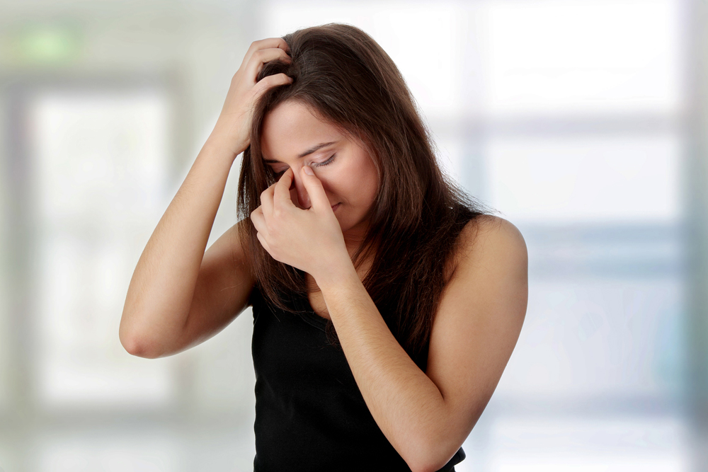 Woman suffering from a sinus headache