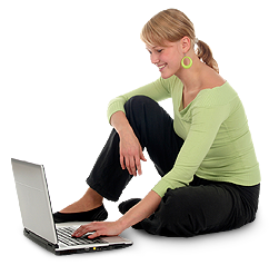 Woman seated on floor using laptop