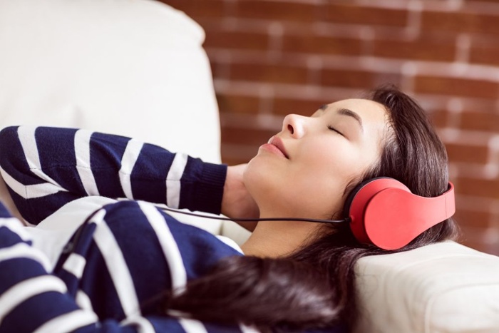 Meditating woman in headphones