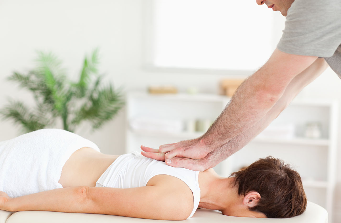 woman getting chiropractic back pain treatment