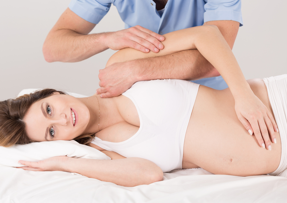 pregnant woman getting chiropractic care in Raleigh
