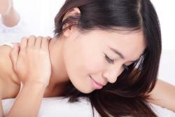 woman holding neck before cold laser treatment in Hudson, FL