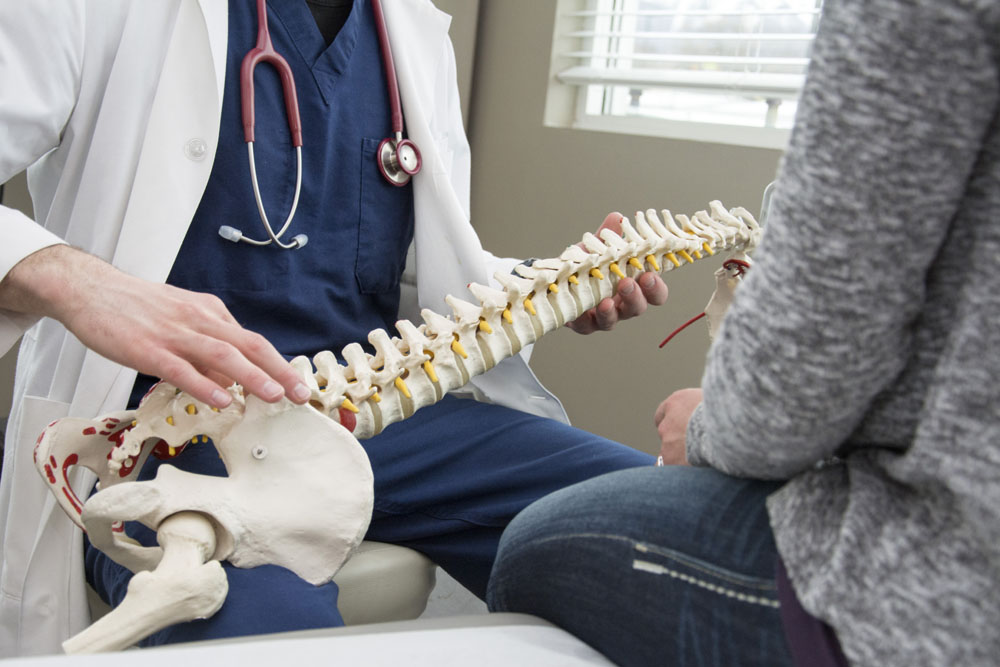 Doctor talking to a patient about Conditions Treated with chiropractic care.