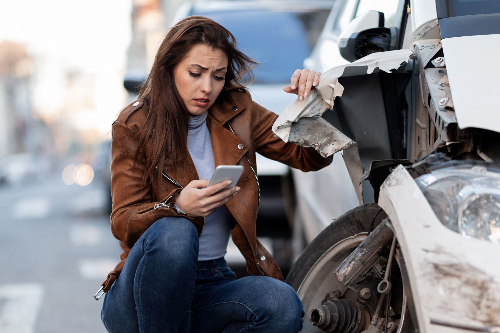 Woman on phone by car crash