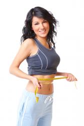 woman holding a tape measure around her waist