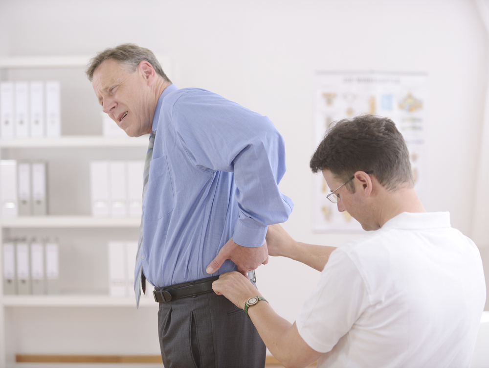 male patient with back pain after an auto accident with chiropractor