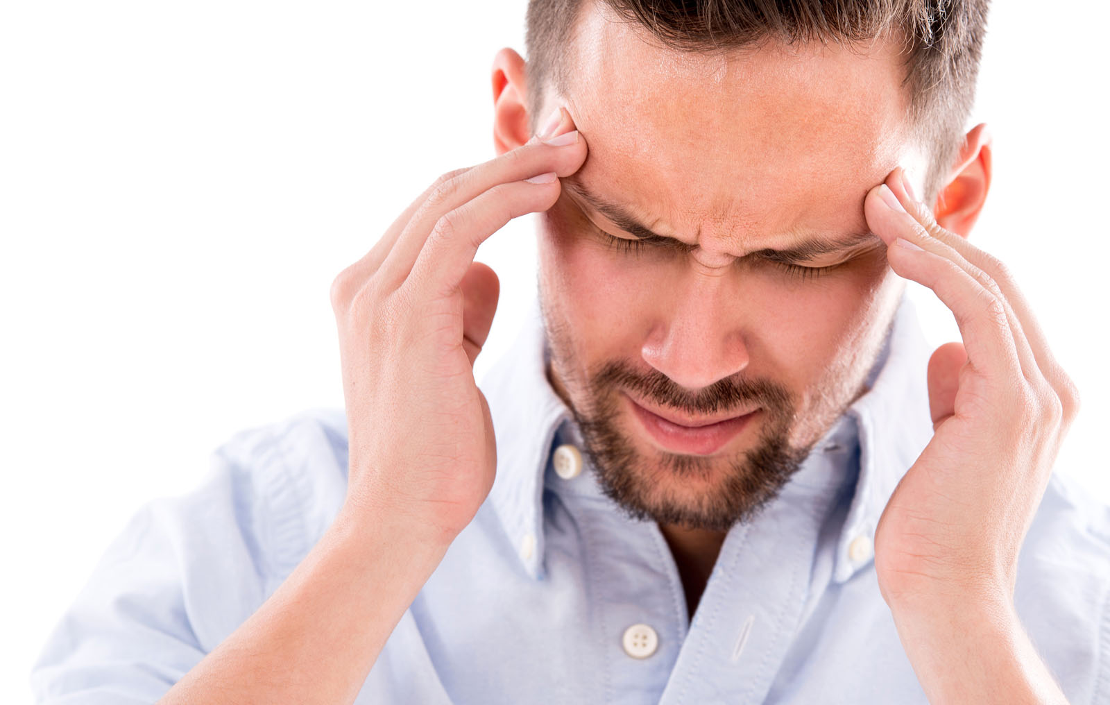man holding his head in pain from migraine