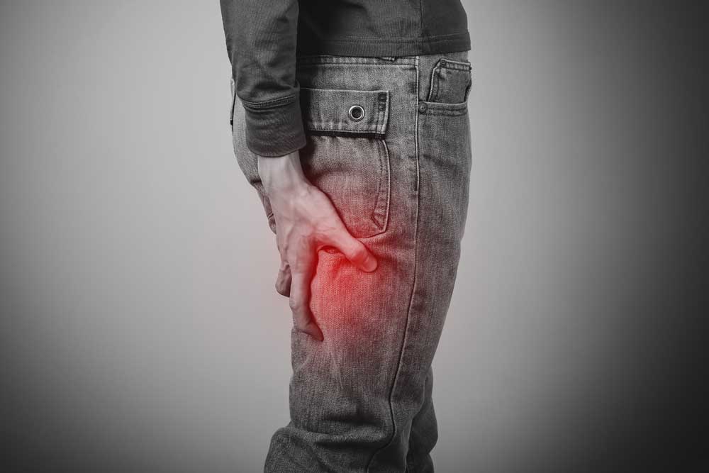 man with sciatica, lower back and leg pain.