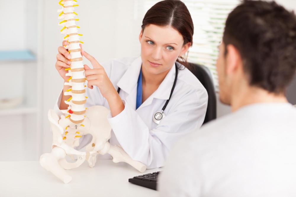woman talking about scoliosis with patient