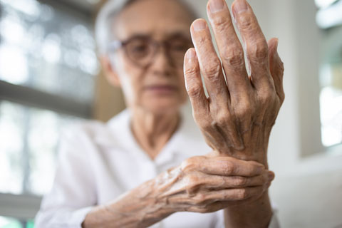 Older women holding her wrist