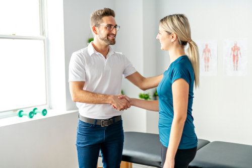 Female client visiting chiropractor for routine chiropractic care
