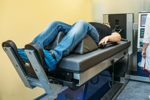 Male client undergoing spinal decompression therapy