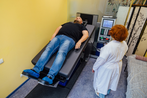 Man undergoing non-surgical spinal decompression therapy