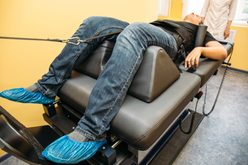 Chiropractic spinal decompression treatment for chronic back pain in man