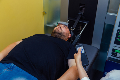 Male client undergoing spinal decompression therapy for back pain relief