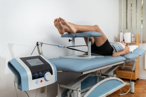 Woman undergoing spinal decompression therapy for back pain at chiropractic clinic