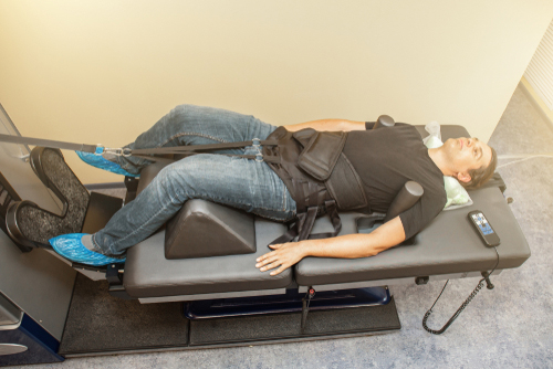 Male client undergoing spinal decompression therapy at chiropractic clinic in Oceanway, Jacksonville, FL