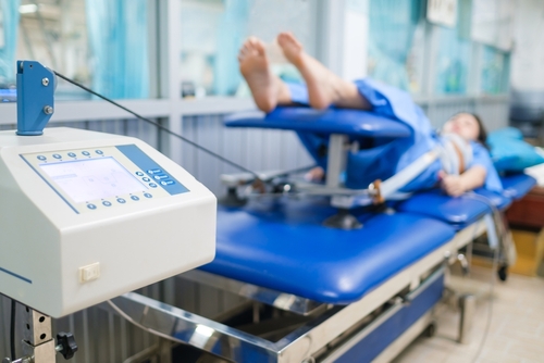 Female client receiving spinal decompression therapy for back pain relief