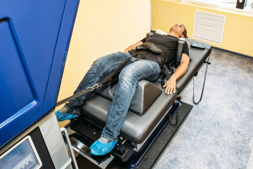 Man undergoing spinal decompression therapy for lower back pain relief