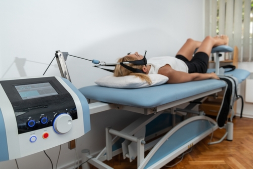 Woman undergoing spinal decompression therapy for chronic lower back pain relief