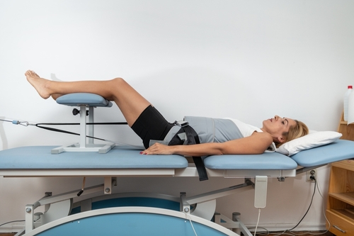 Female patient undergoing spinal decompression therapy for lower back pain relief