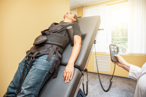 Male client undergoing spinal decompression therapy at chiropractic clinic in Orange Park, FL
