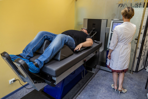Man undergoing spinal decompression therapy with chiropractor