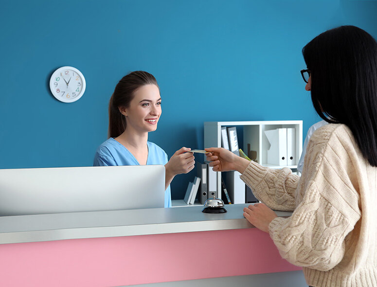 new patient signing in with the receptionist